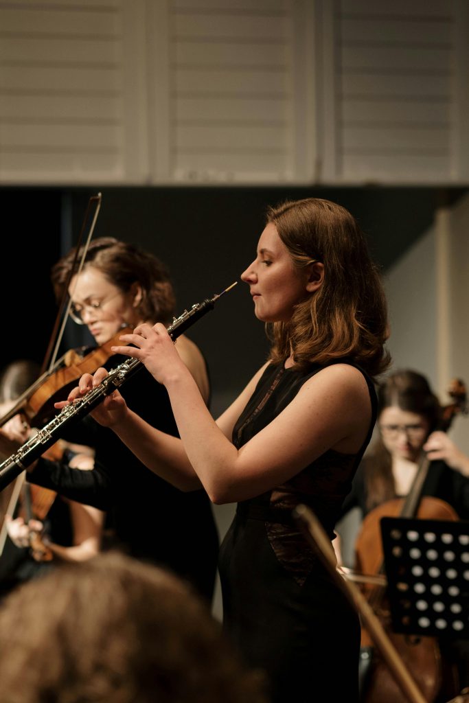 A group of female musicians playing classical instruments during a live performance.